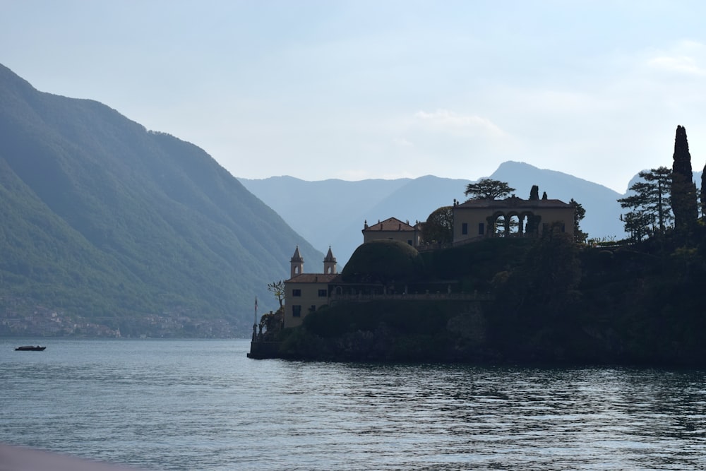 a house on a small island in the middle of a lake