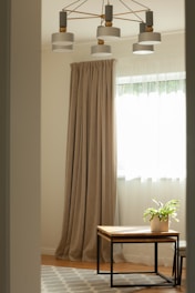 a living room with a coffee table and curtains
