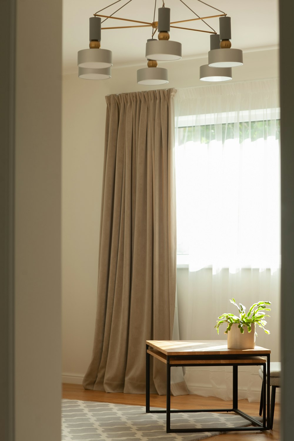 a living room with a coffee table and curtains