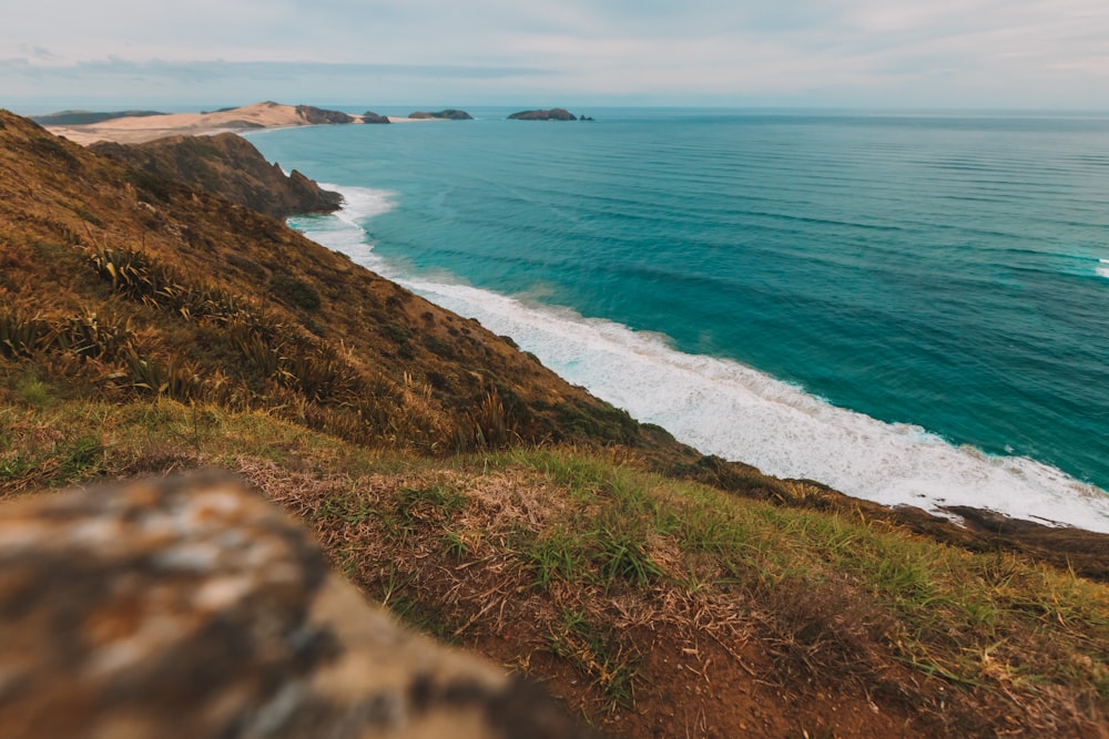 a view of the ocean from the top of a hill