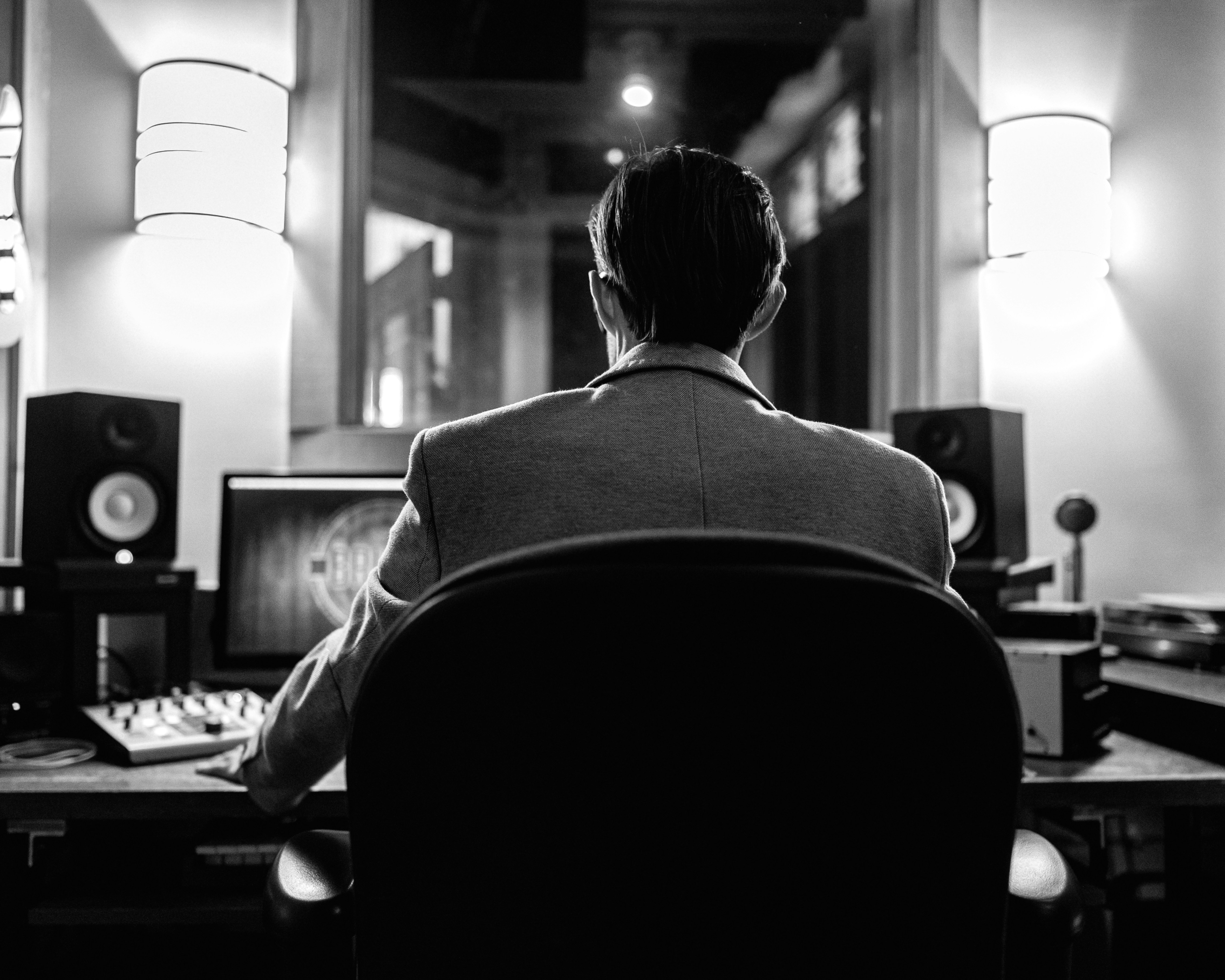 a man sitting at a desk in front of a computer
