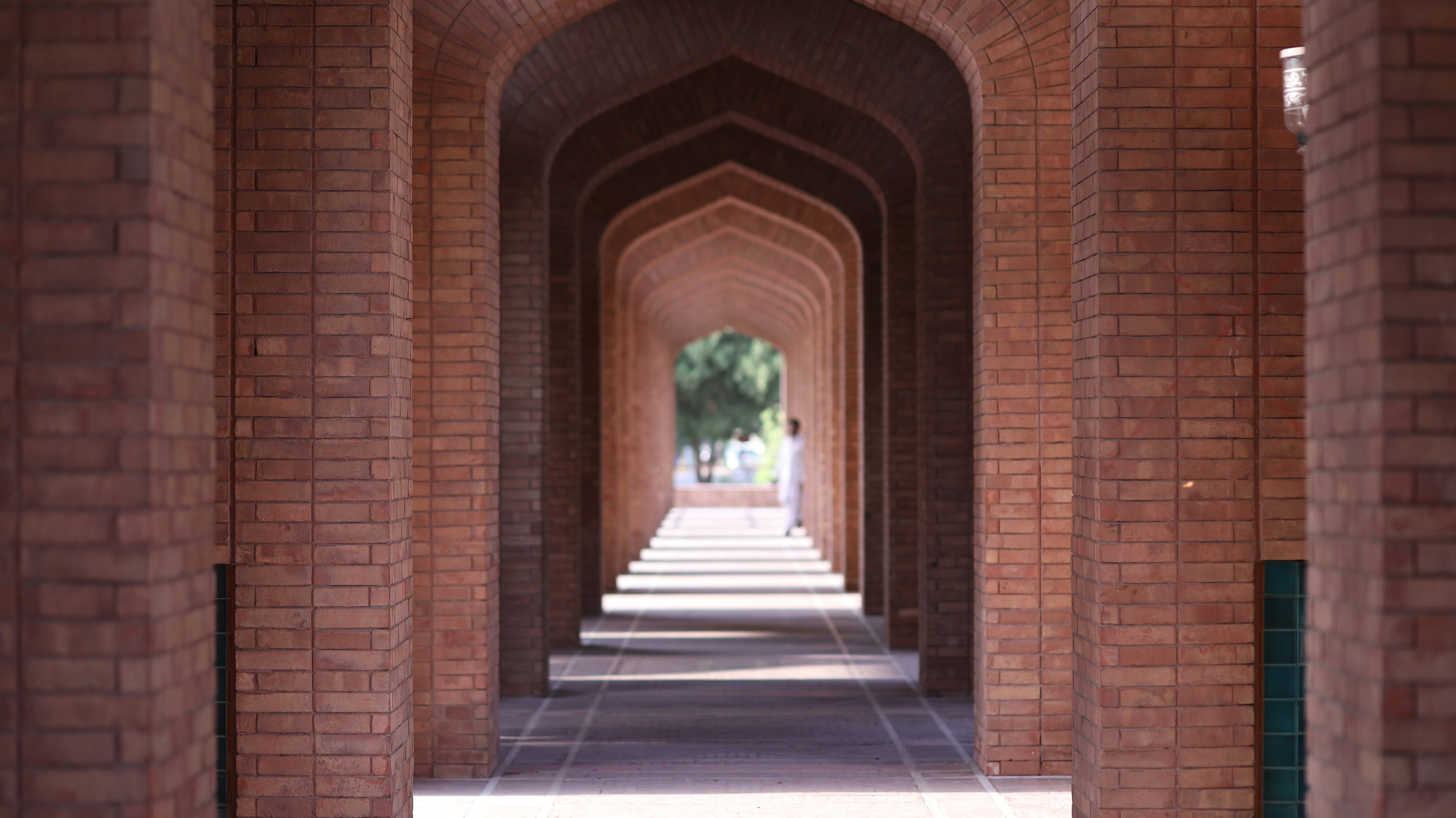 a row of archways with a clock on each of them