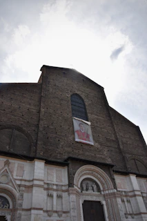 A vintage photograph of the Sheriff of Gloucester in traditional ceremonial robes standing proudly outside Gloucester Cathedral.