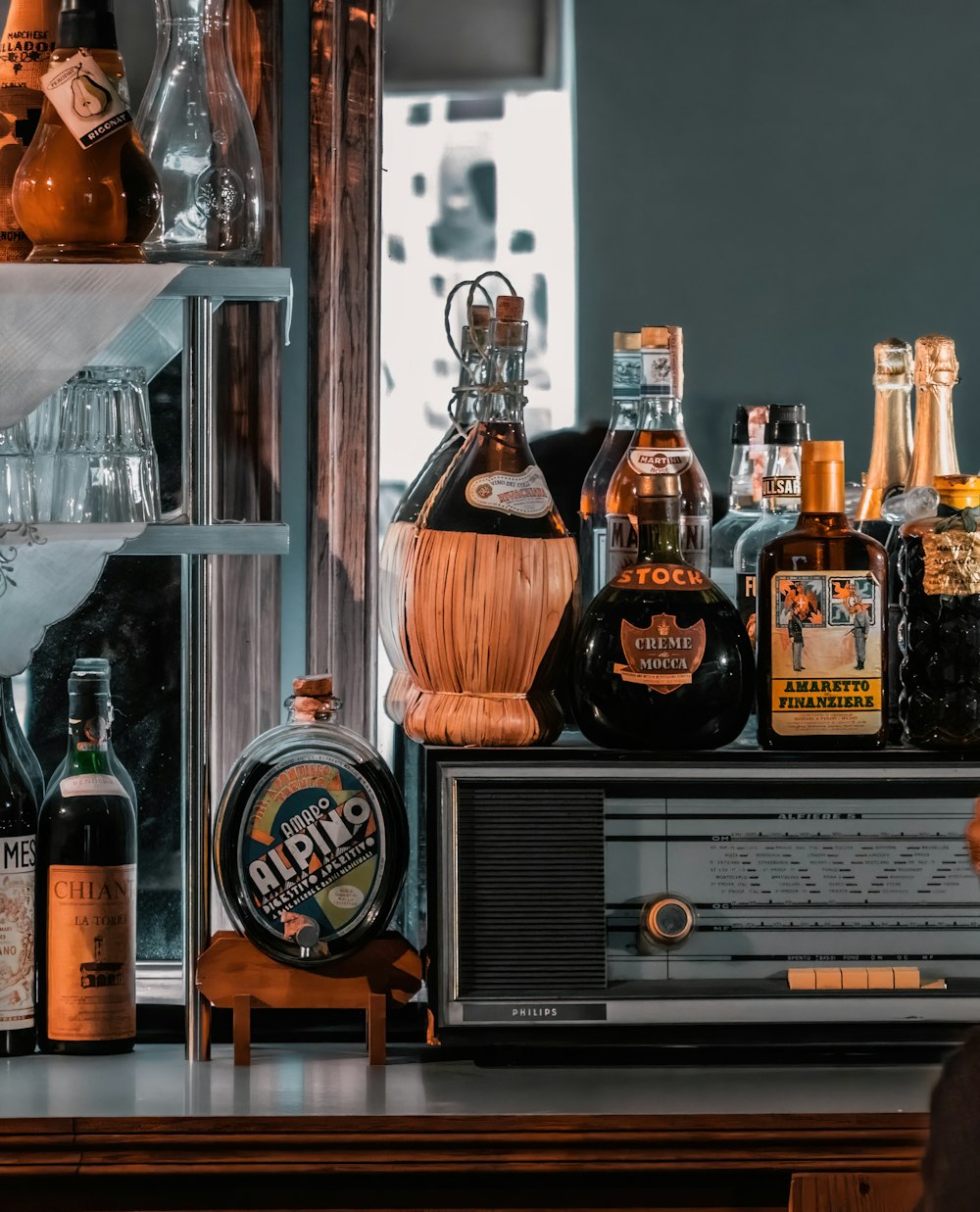 a bunch of liquor bottles sitting on top of a shelf