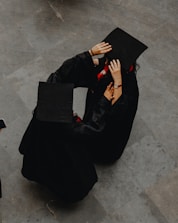 A photographer interacting with a graduate.