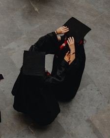 A photographer interacting with a graduate.