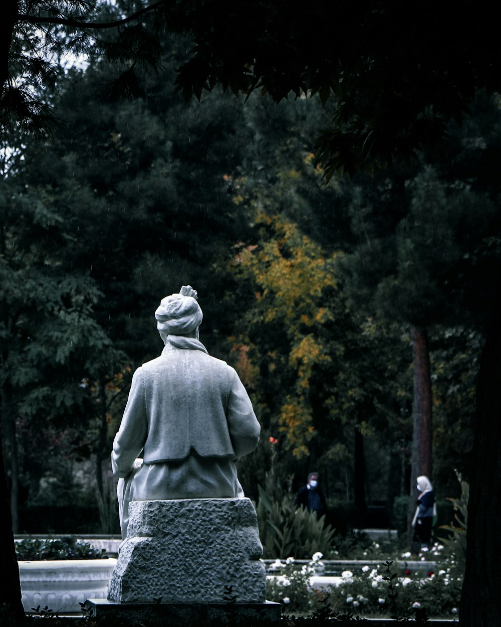 a woman sitting on a bench in a park