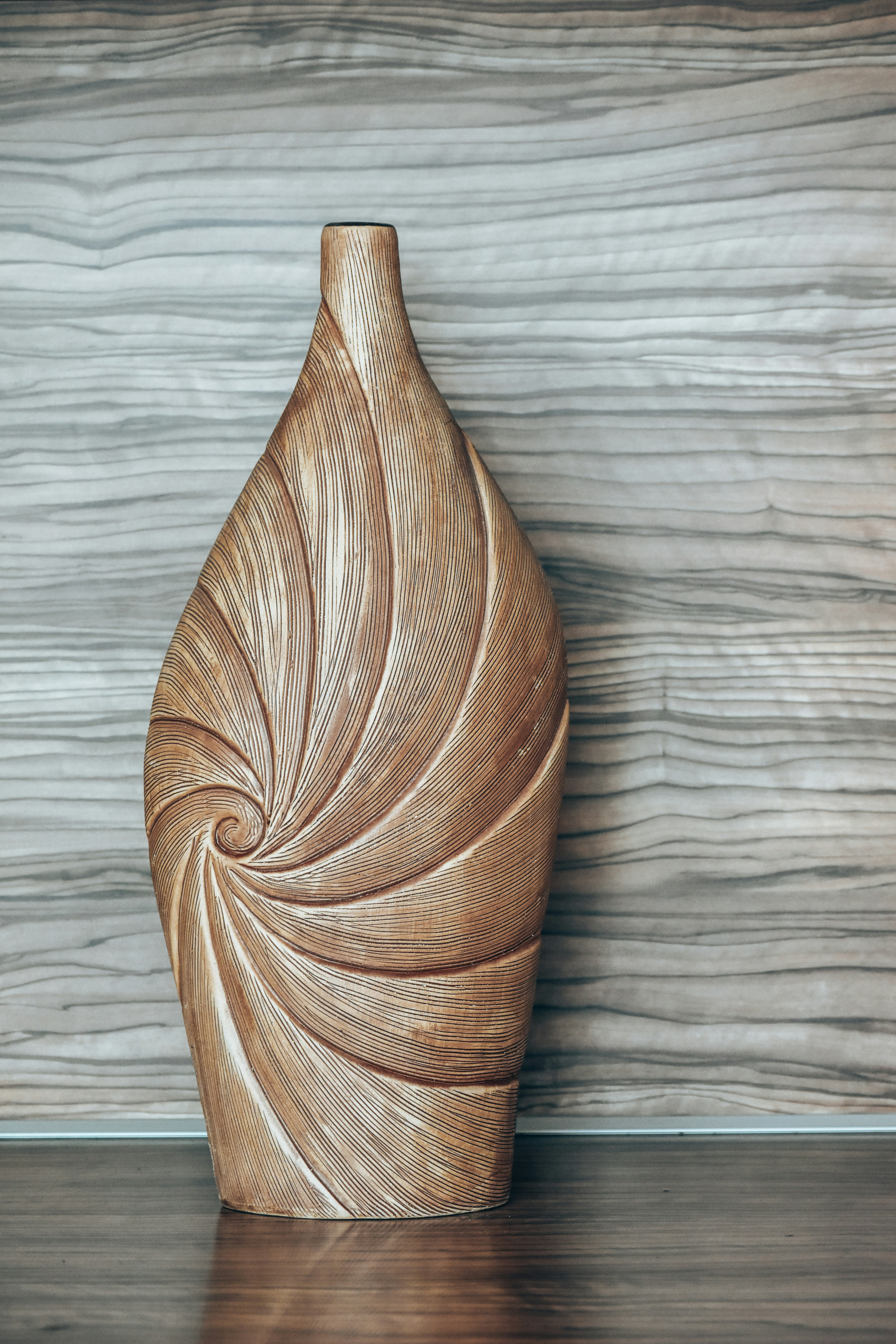 a wooden vase sitting on top of a wooden table