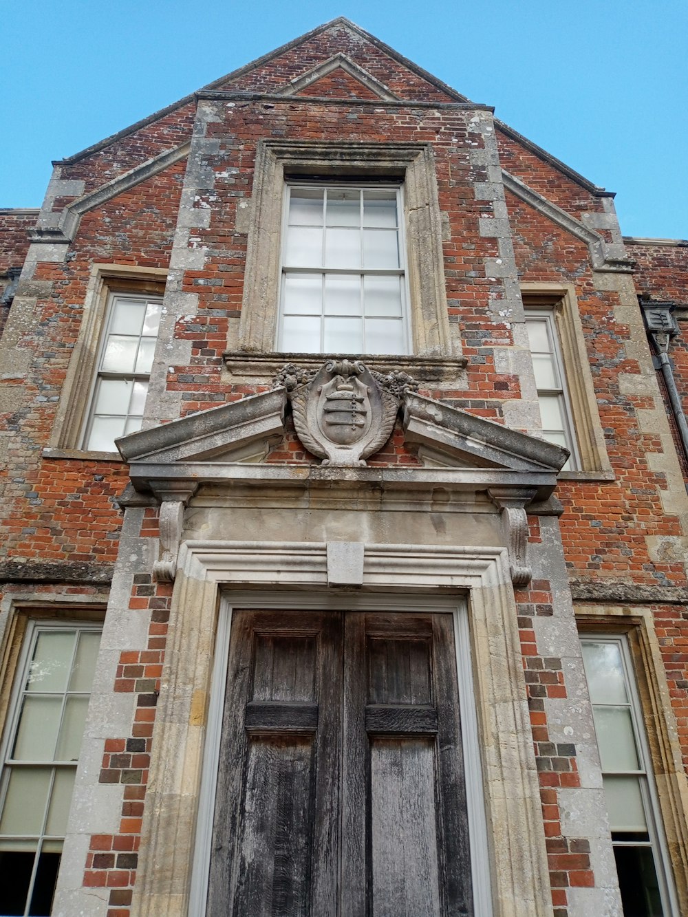 an old brick building with a wooden door