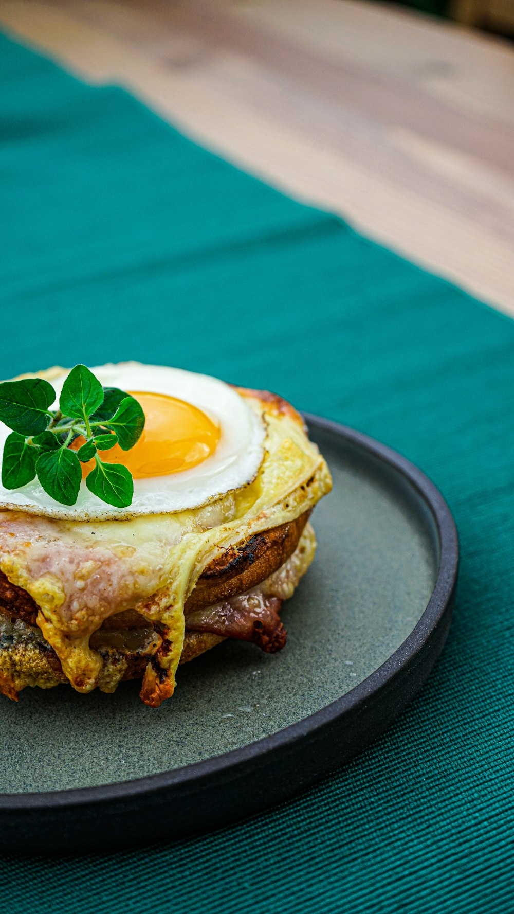 a breakfast sandwich with an egg on top of it