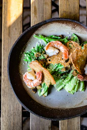 a plate of food on a wooden table