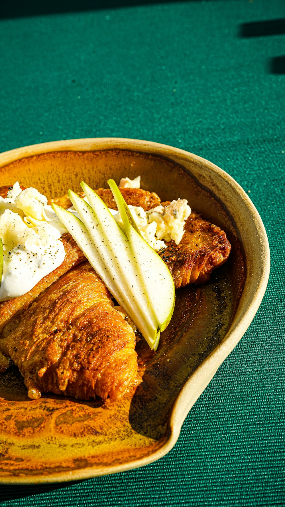 a plate of food on a green table