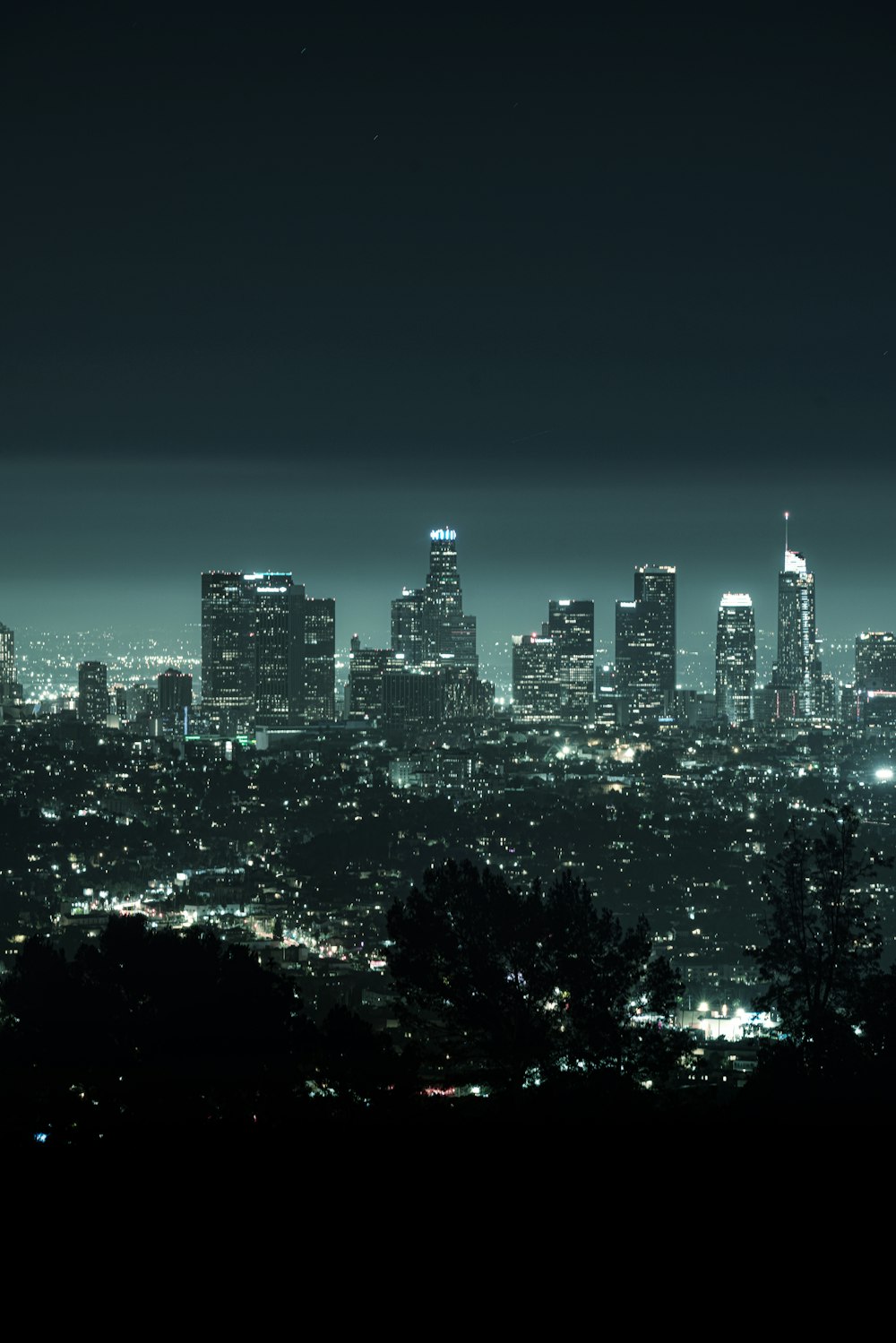 a view of a city at night from the top of a hill