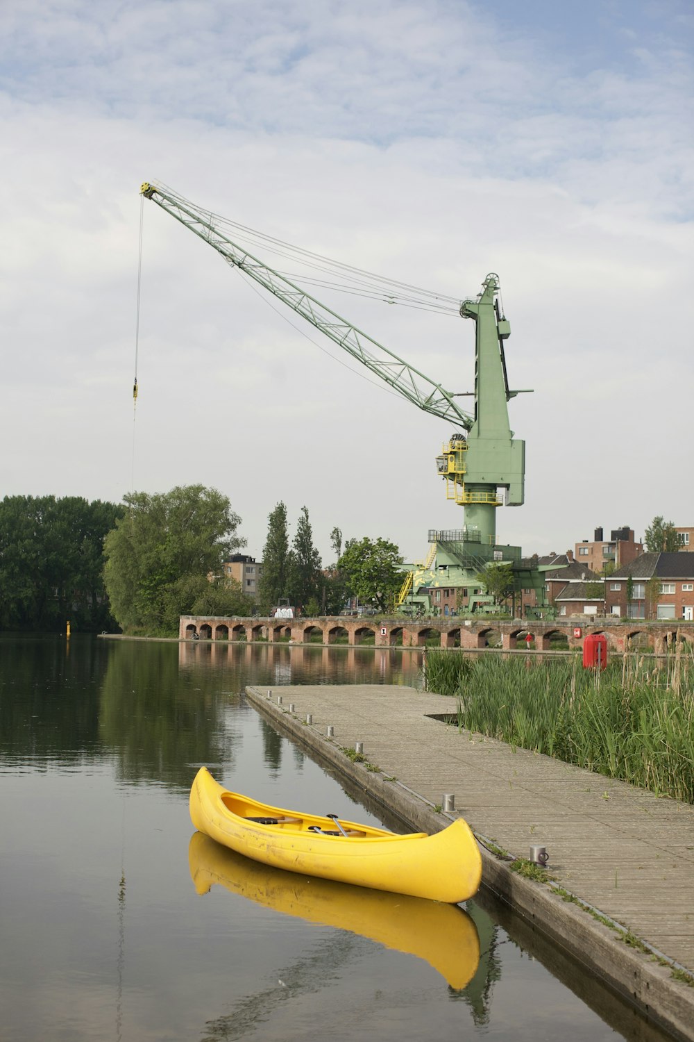 a yellow kayak sitting on the side of a river