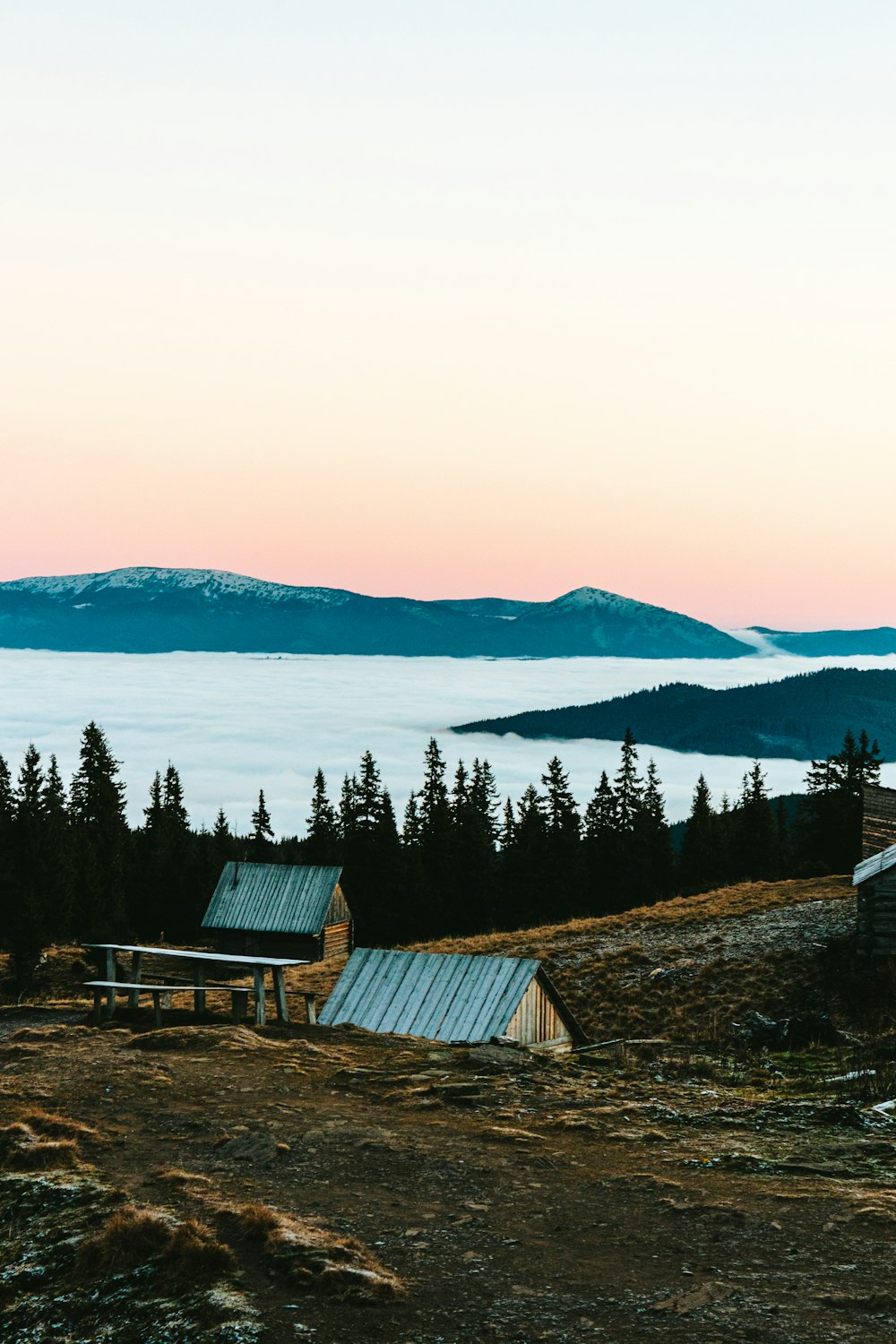 a couple of buildings sitting on top of a hill