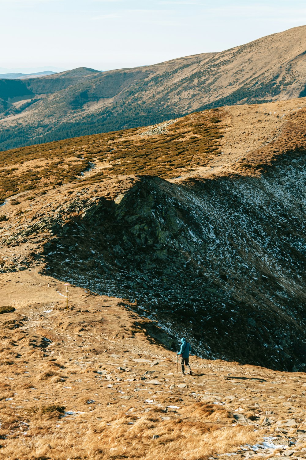 a person walking up a hill on a sunny day