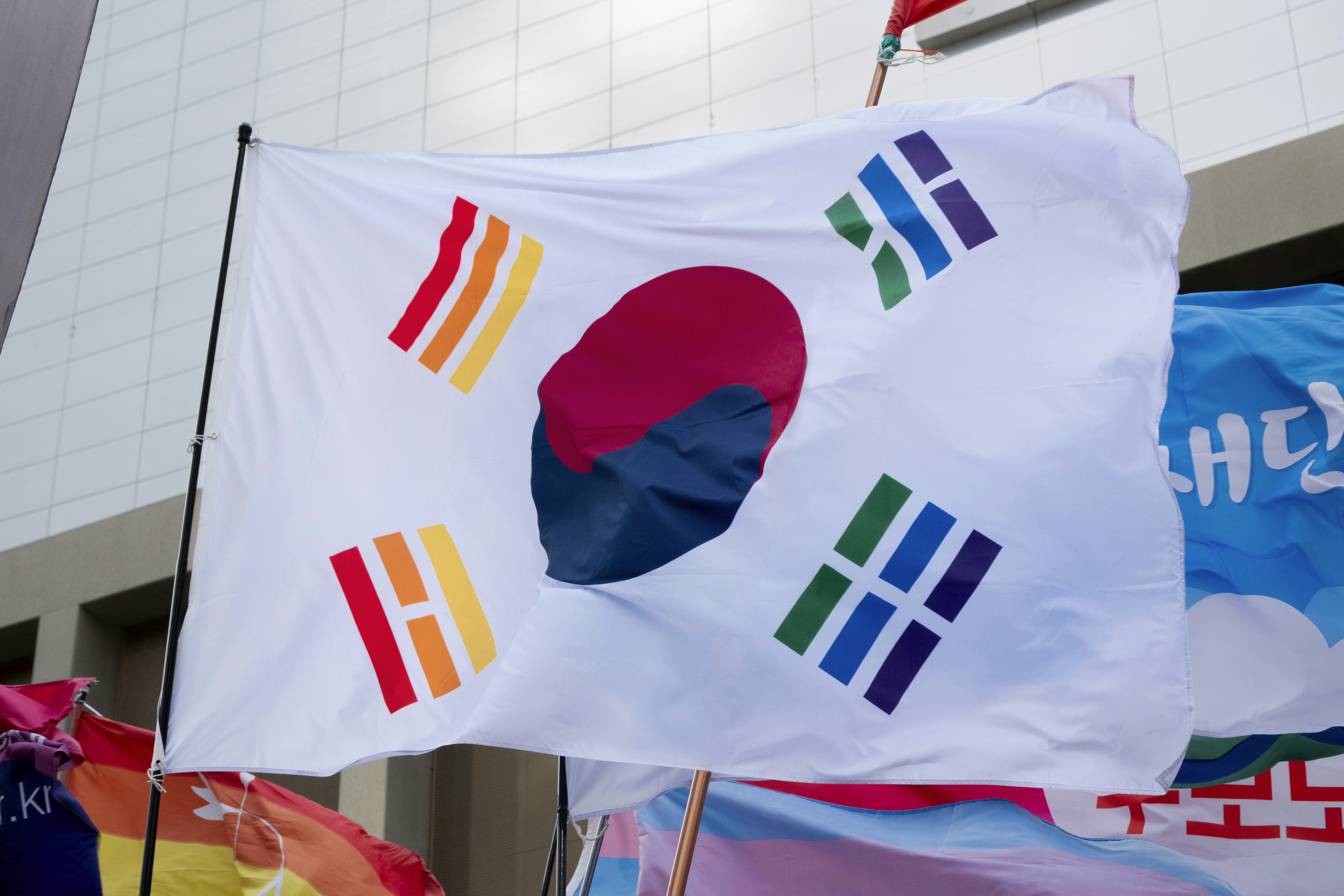 a bunch of flags that are outside of a building