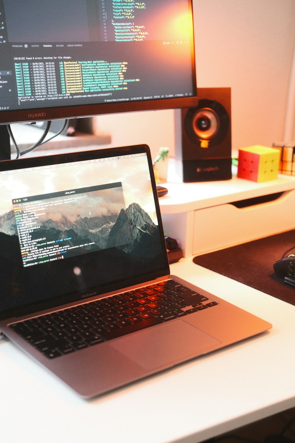 a laptop computer sitting on top of a white desk