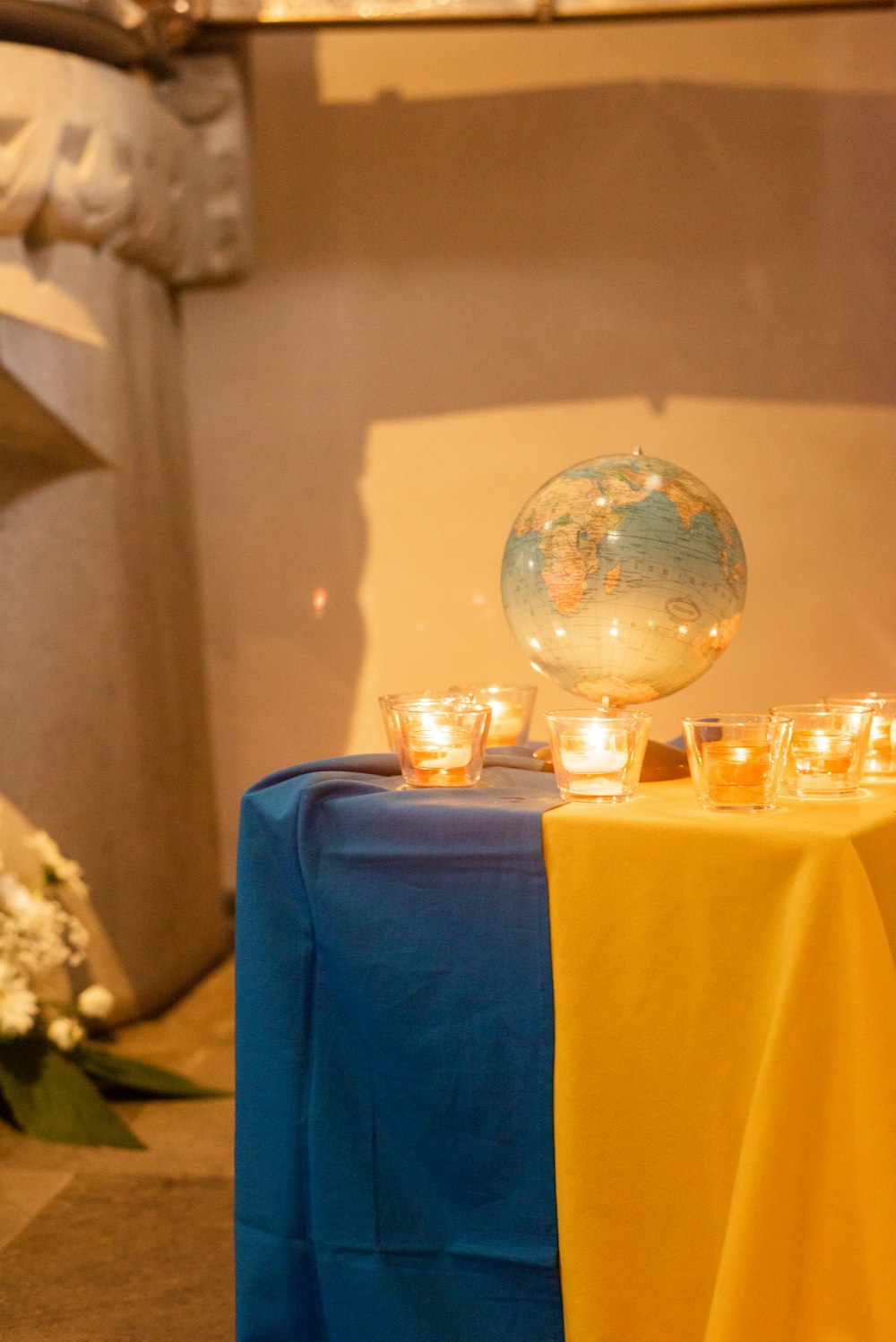 a table with candles and a globe on it