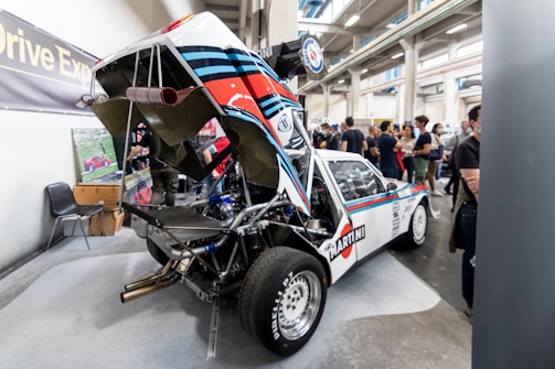 A limited-production sports car being carefully inspected by an expert.