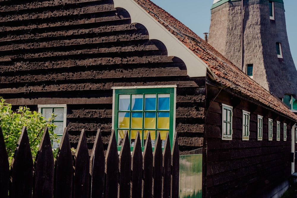 a wooden house with a green door and window