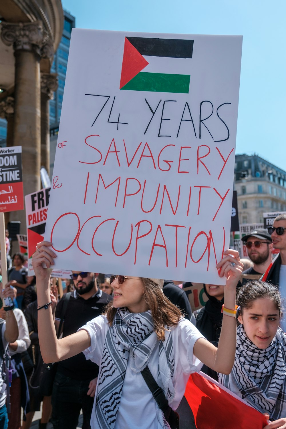 a group of people holding up signs in a protest