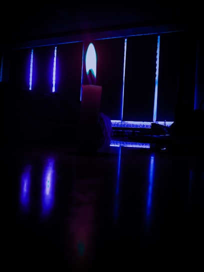 A dimly lit room with candles casting shadows, evoking mystery and emotional depth.