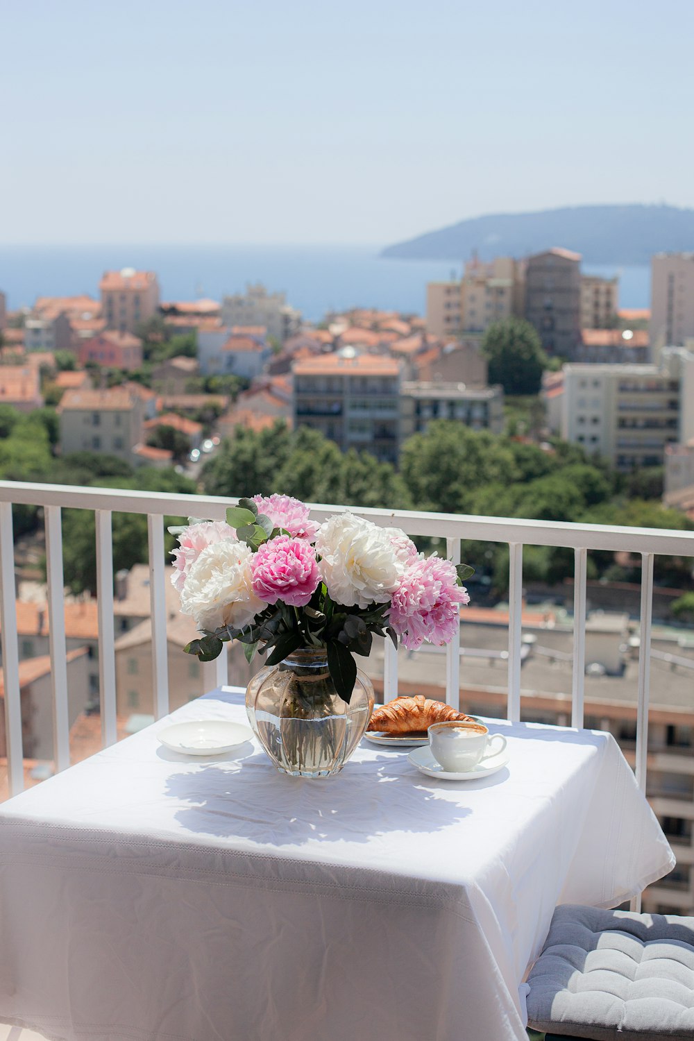 a pink flower on a table