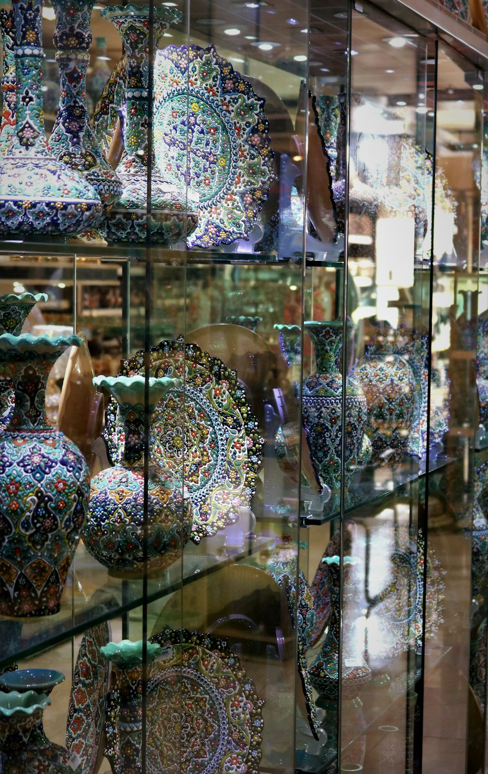 a display case filled with lots of colorful vases