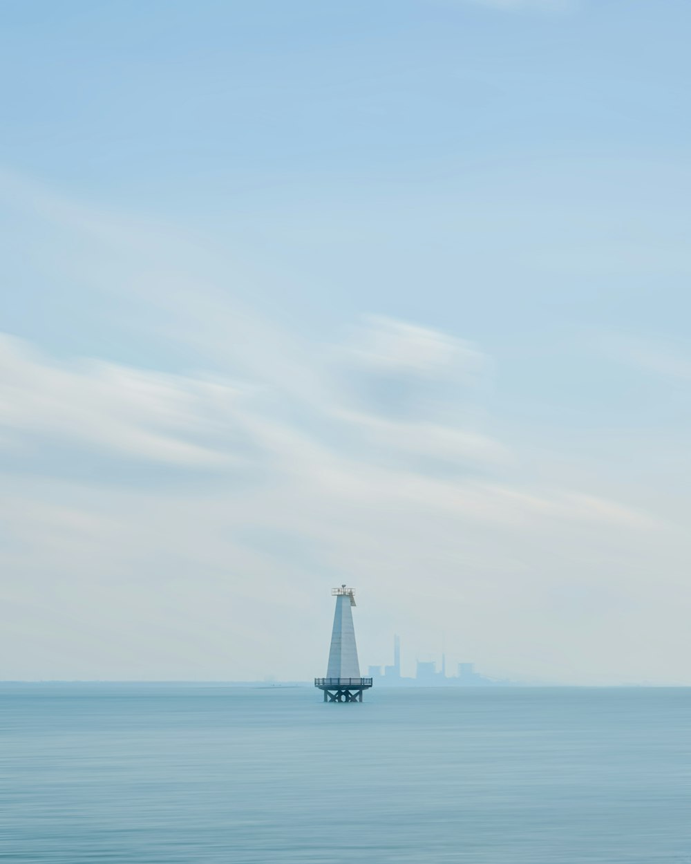 a large body of water with a tower in the middle of it