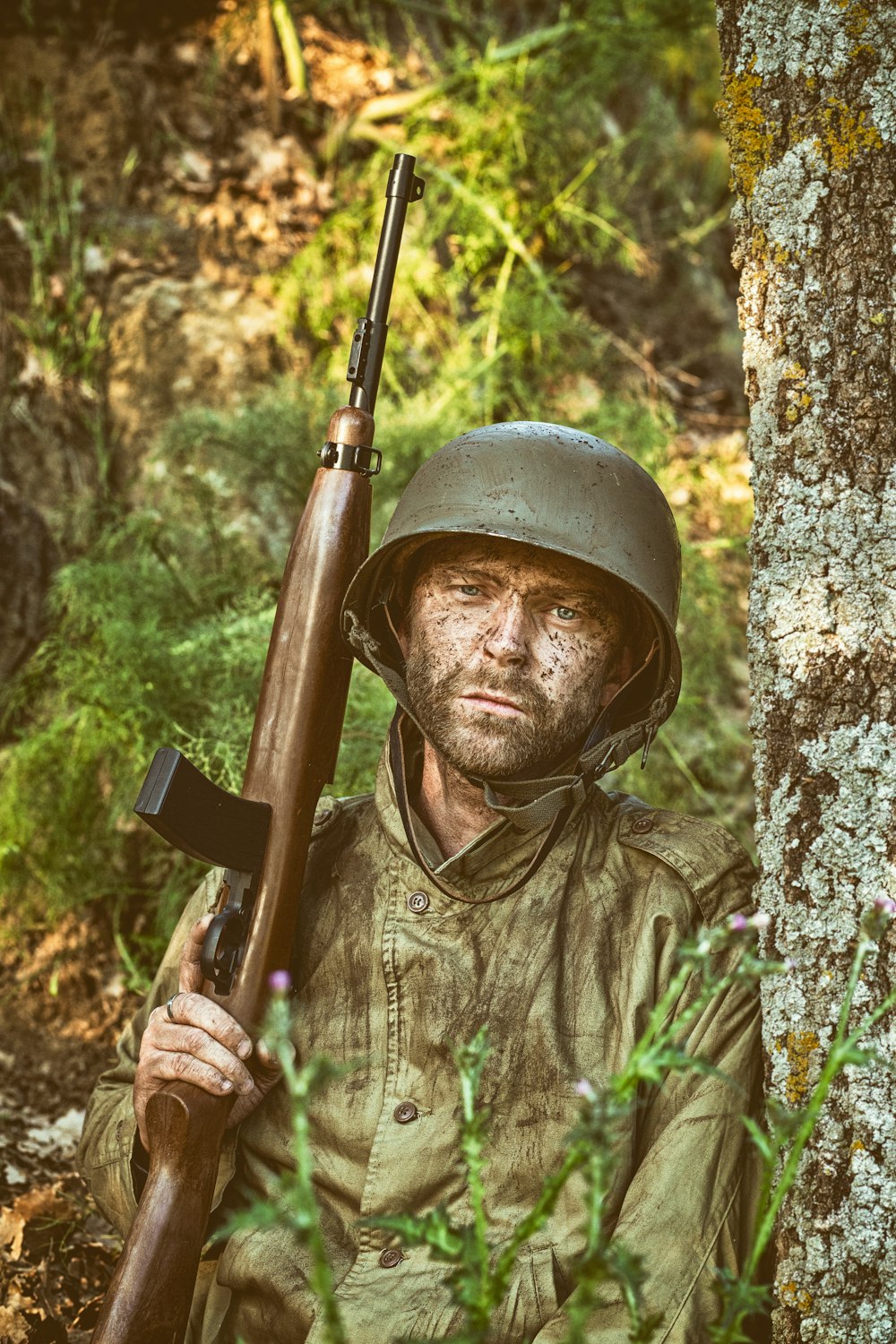 a man in a helmet holding a rifle