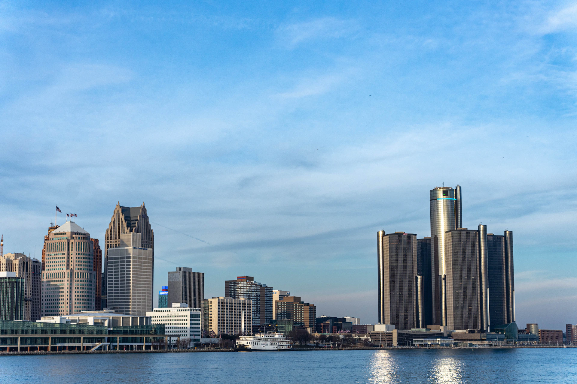 a large body of water with a city in the background