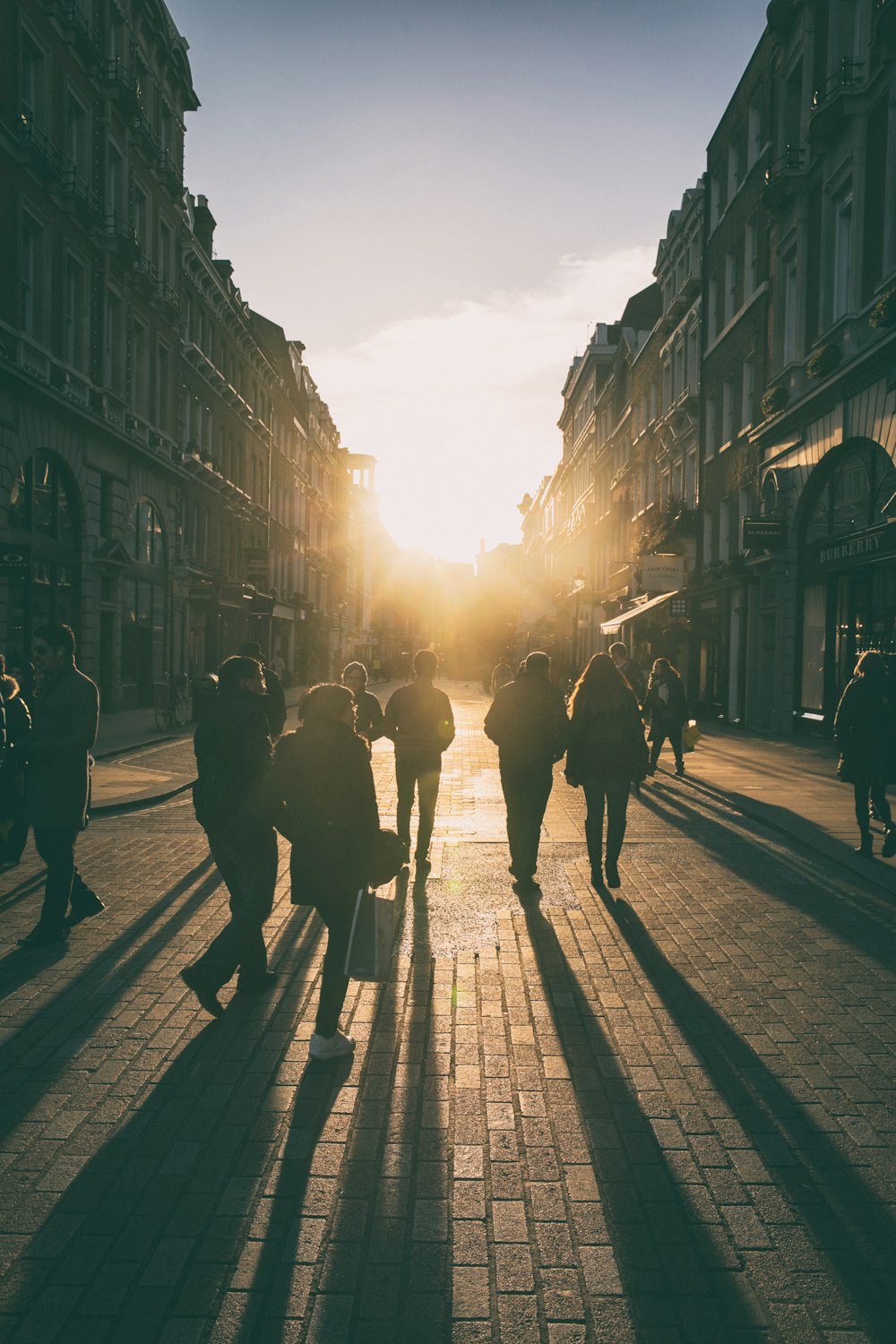 a group of people walking down the street