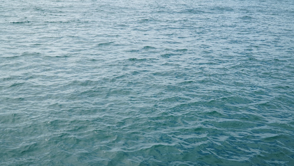 a boat floating on top of a large body of water