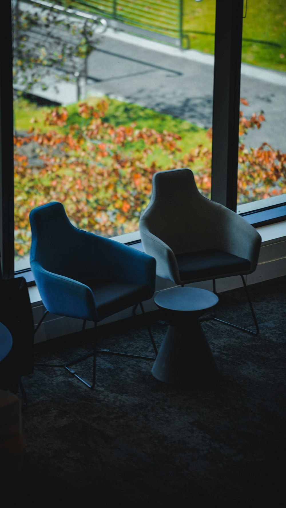 a couple of chairs sitting in front of a window