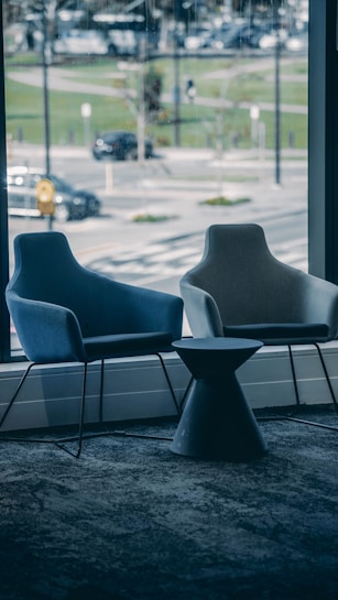 a couple of chairs sitting next to a window