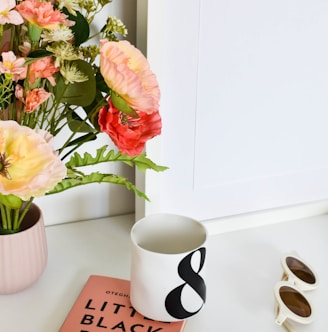 a book and a vase of flowers on a table