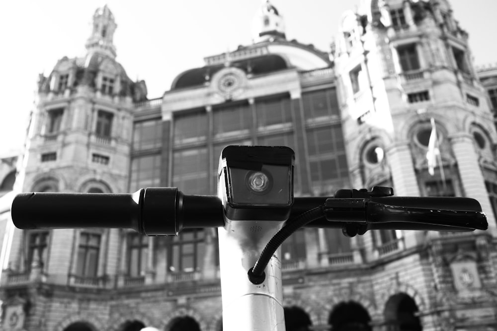 a camera attached to a pole in front of a building