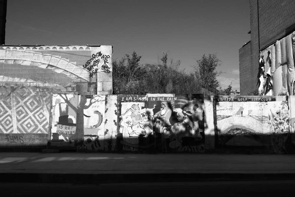 a black and white photo of graffiti on a wall