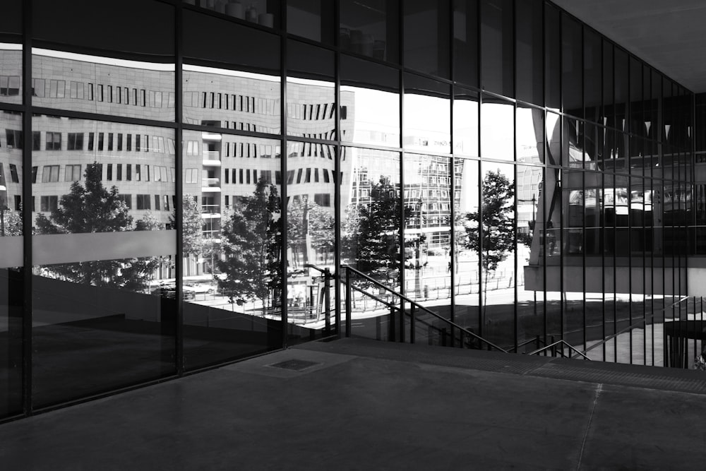 a black and white photo of a building's reflection