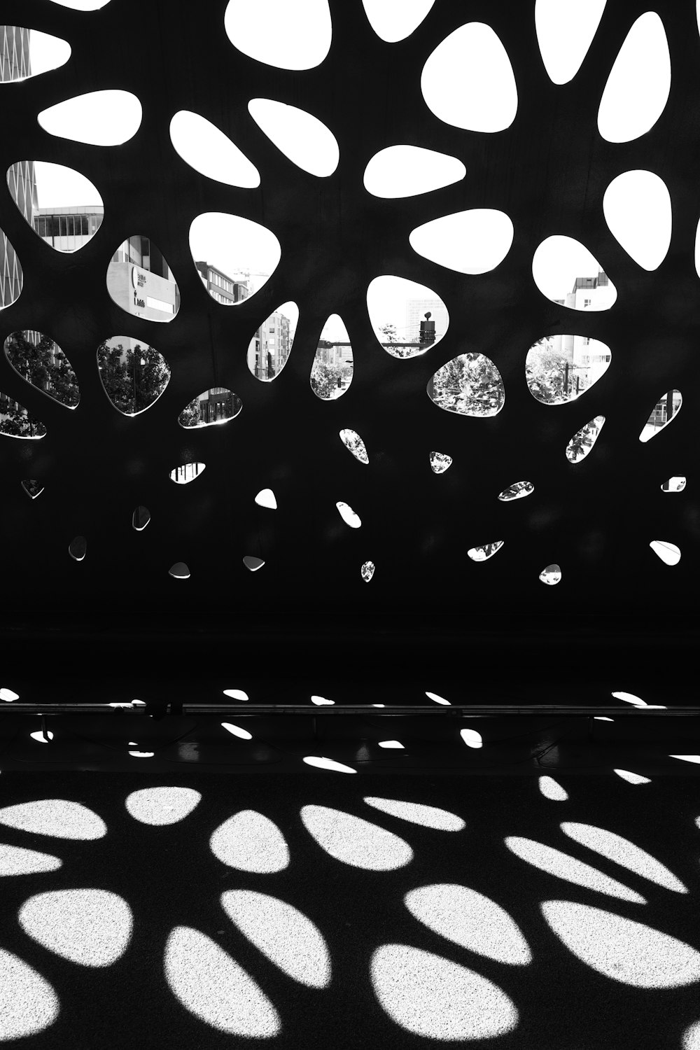 a black and white photo of a building with lots of circles on it