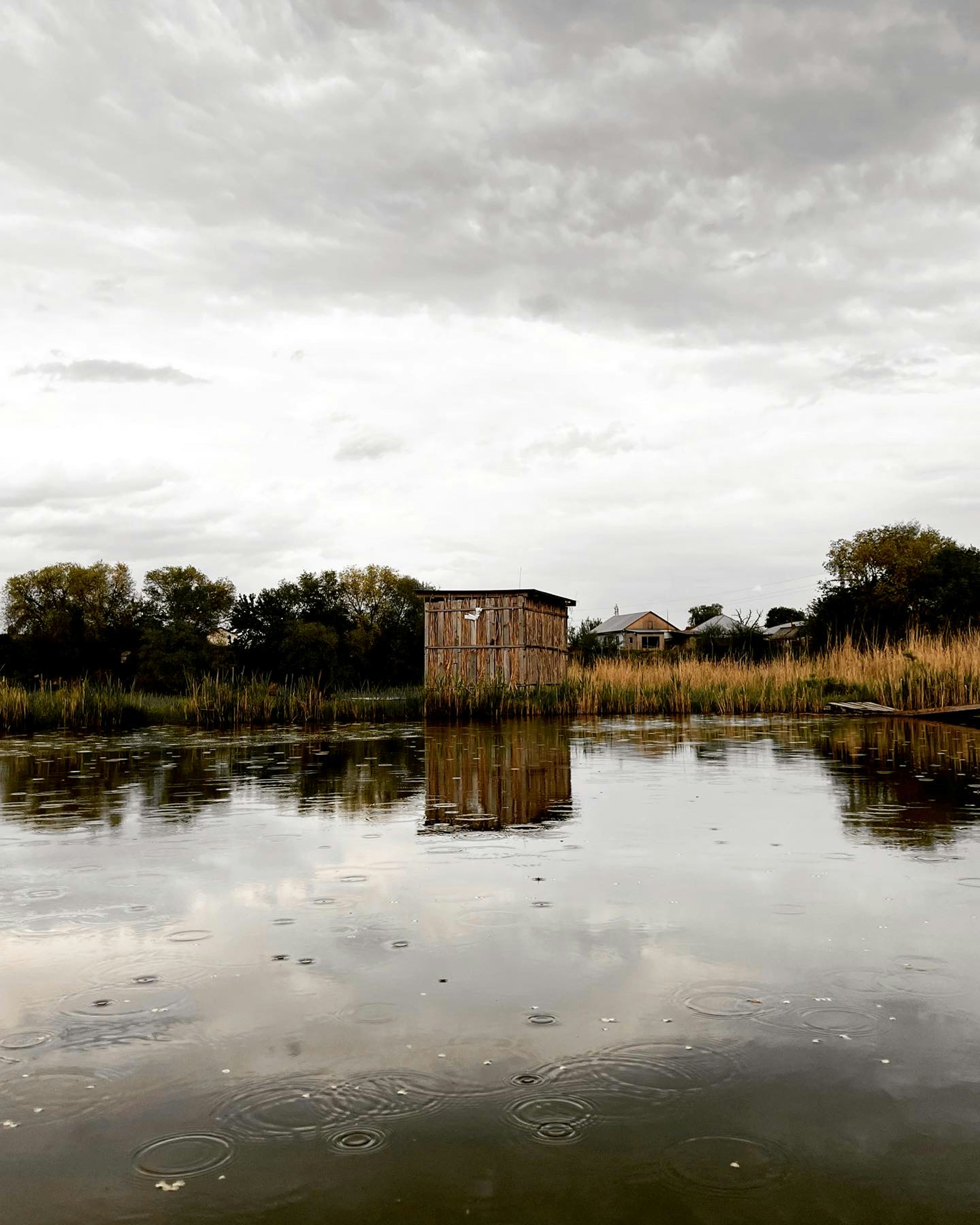 a body of water with a building in the background