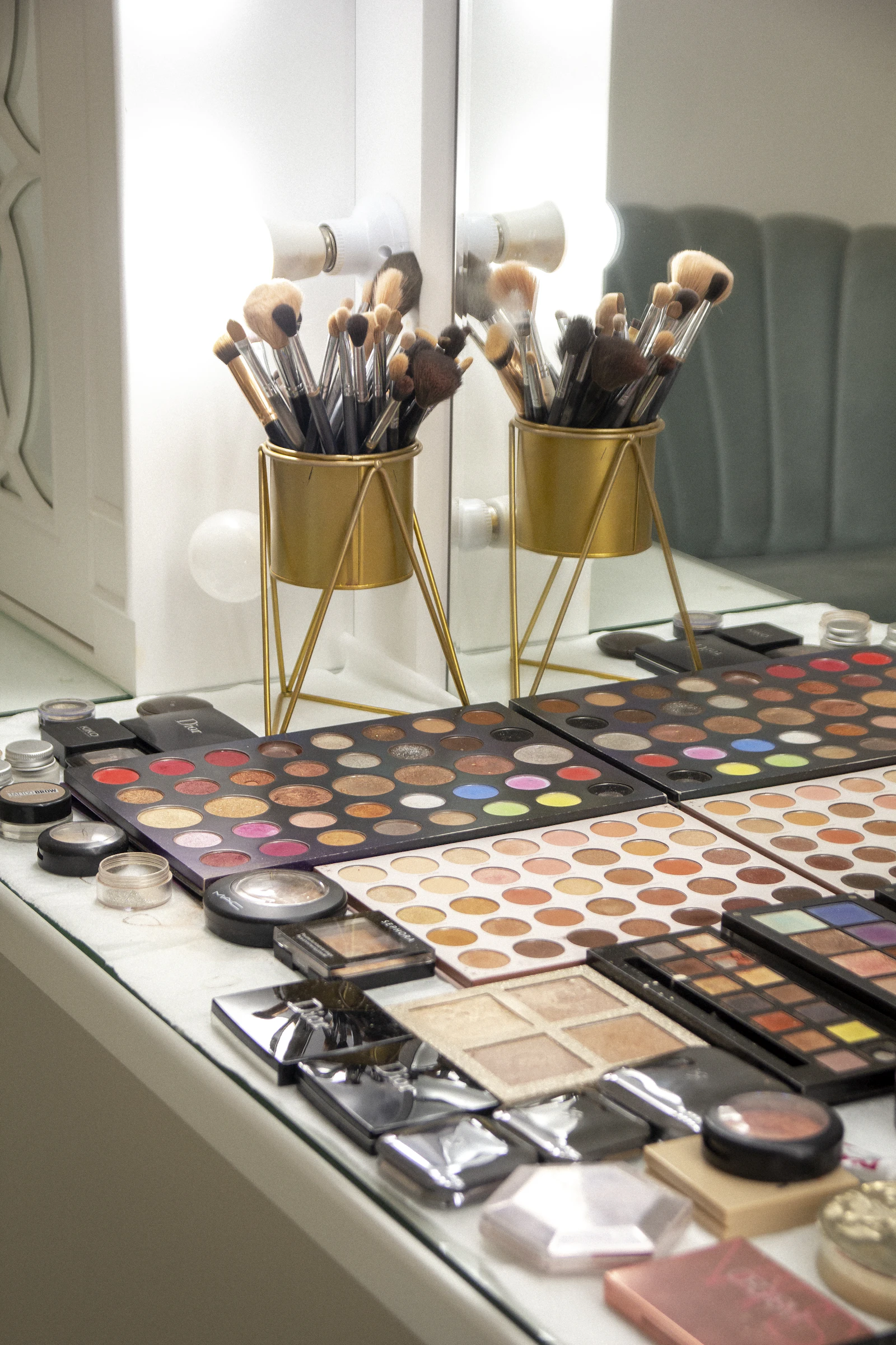 A table laid out with professional makeup products and brushes