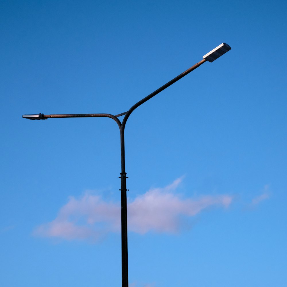 a street light with a blue sky in the background