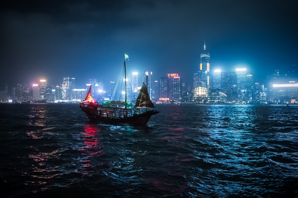 a boat in the water with a city in the background