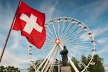 a large ferris wheel sitting next to a statue