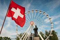 a large ferris wheel sitting next to a statue