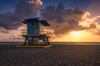 a lifeguard tower sitting on top of a sandy beach
