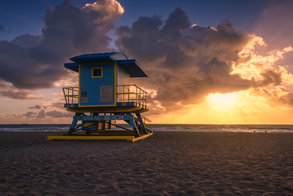 a lifeguard tower sitting on top of a sandy beach