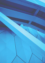 A modern architectural blueprint overlaying a deep cobalt blue background, symbolizing precision and creativity.
